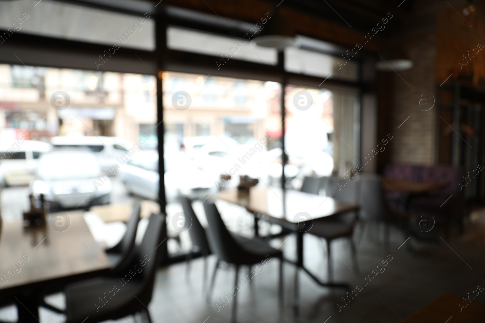 Photo of Blurred view of stylish modern cafe interior with bokeh effect