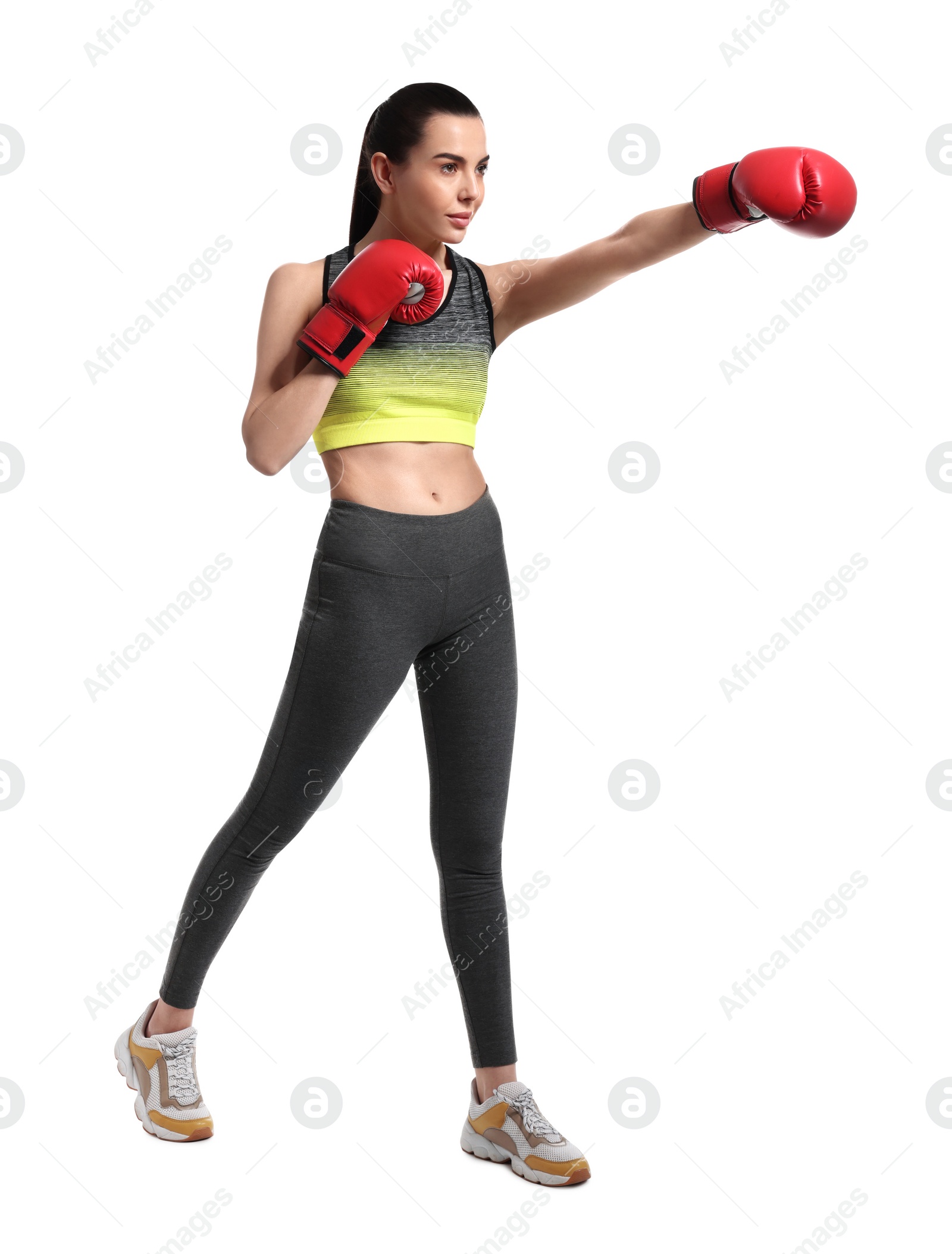 Photo of Beautiful woman in boxing gloves training on white background