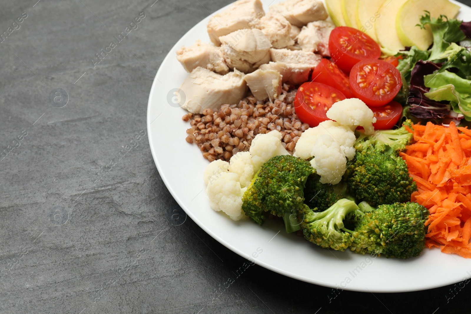 Photo of Balanced diet and healthy foods. Plate with different delicious products on black table, closeup. Space for text