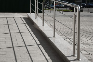 Photo of Ramp with metal handrail near building outdoors