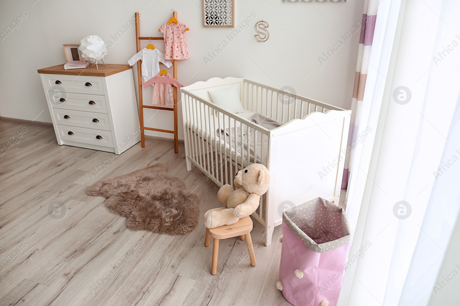 Photo of Cozy baby room interior with crib