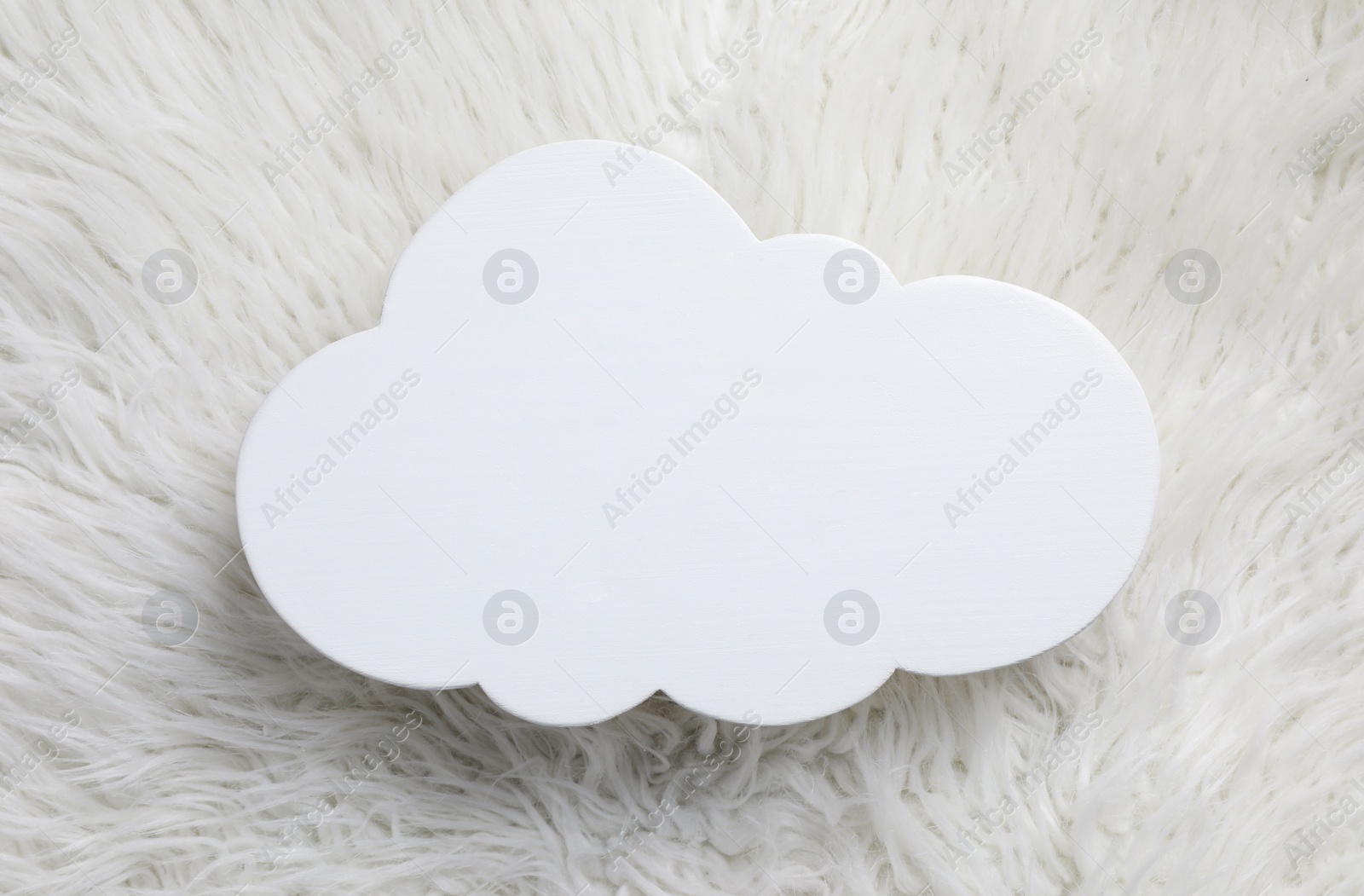 Photo of Cloud shaped child's night lamp on white faux fur, top view