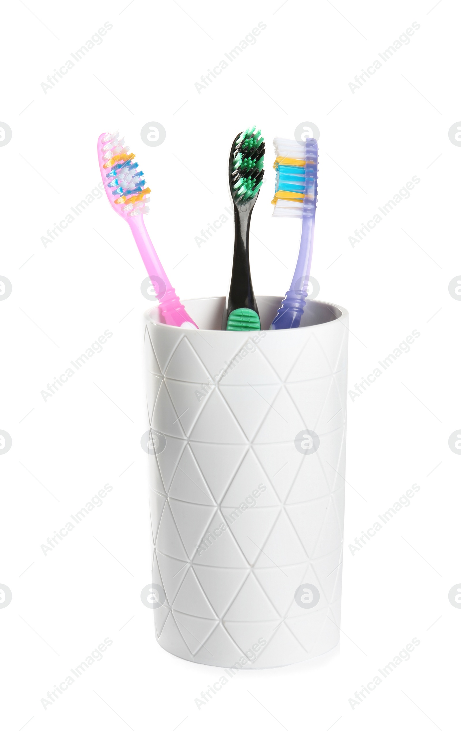 Photo of Cup with different toothbrushes on white background. Dental care