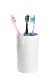 Photo of Cup with different toothbrushes on white background. Dental care