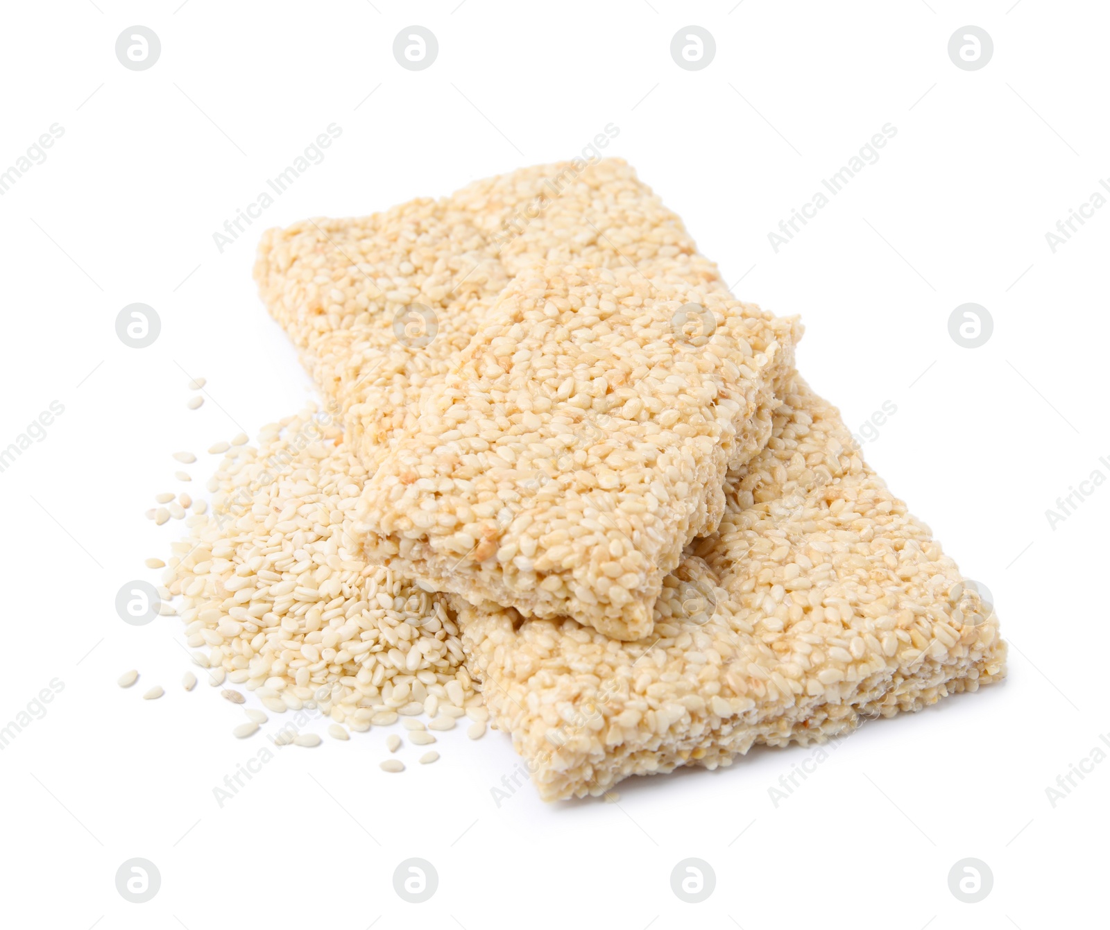 Photo of Delicious sweet kozinaki bars and sesame seeds on white background