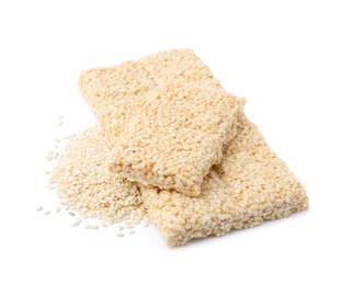 Delicious sweet kozinaki bars and sesame seeds on white background