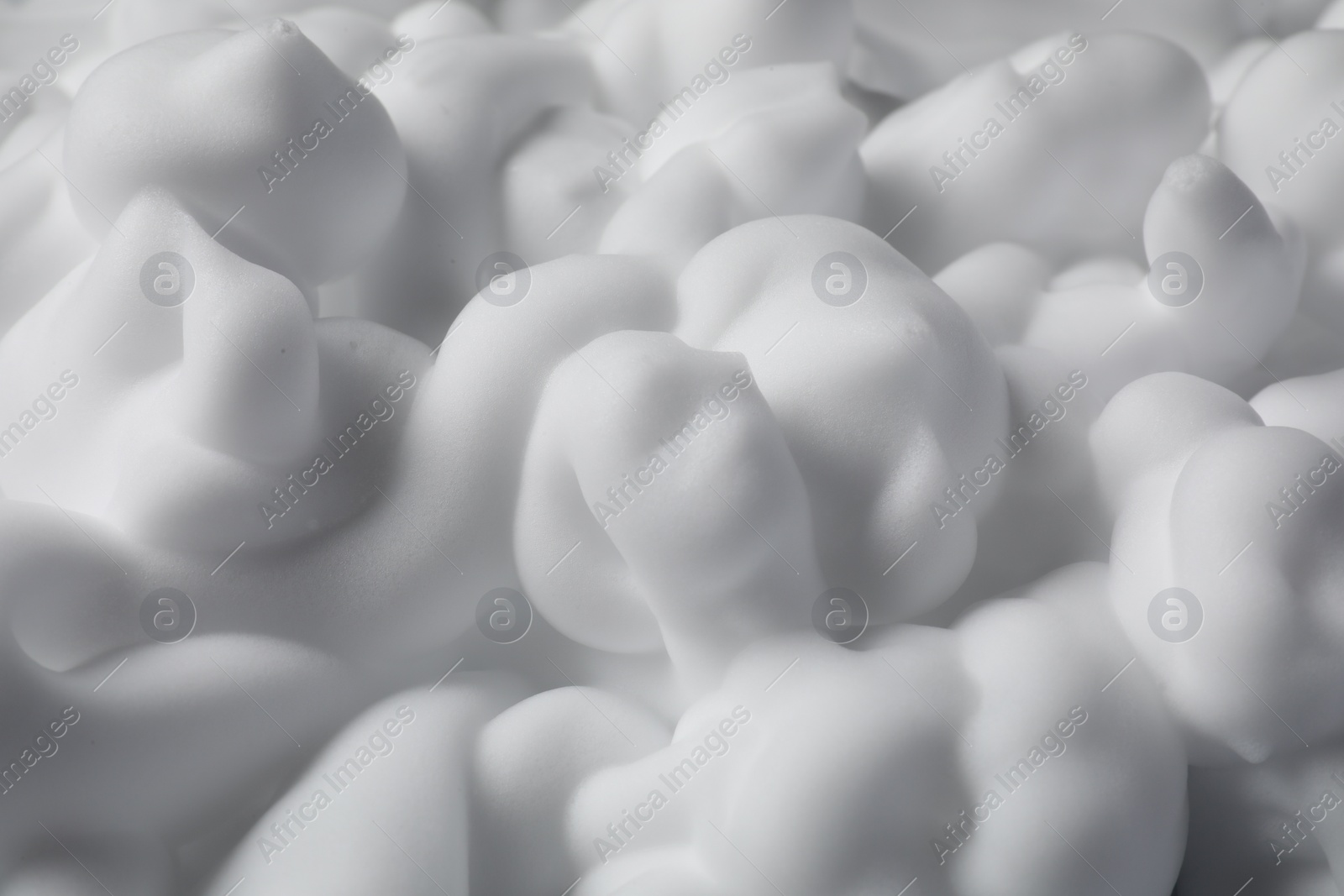 Photo of Texture of white shaving foam as background, closeup