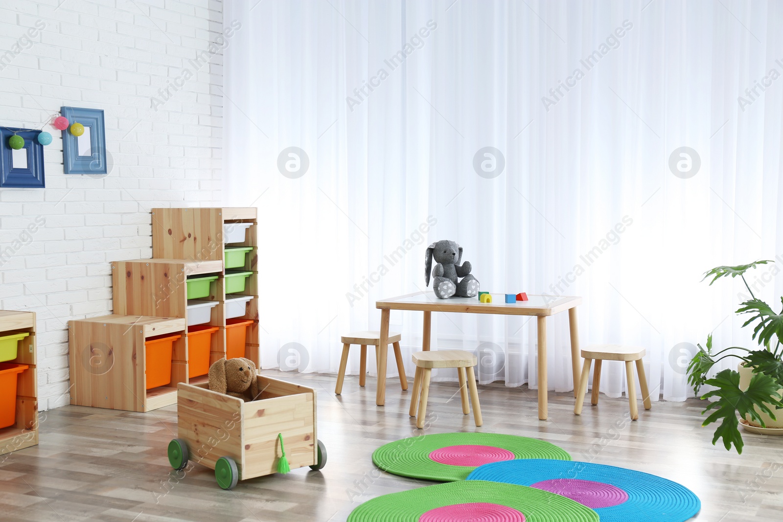 Photo of Modern child room interior with table and stools