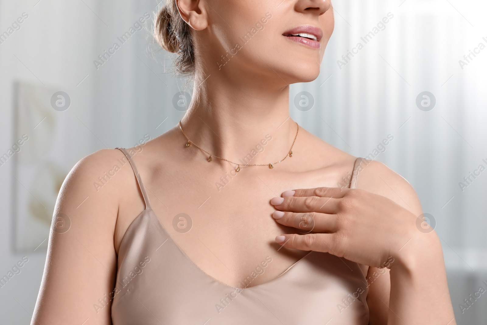 Photo of Woman with elegant necklace on blurred background, closeup