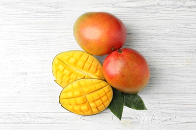 Photo of Flat lay composition with mango on white wooden background