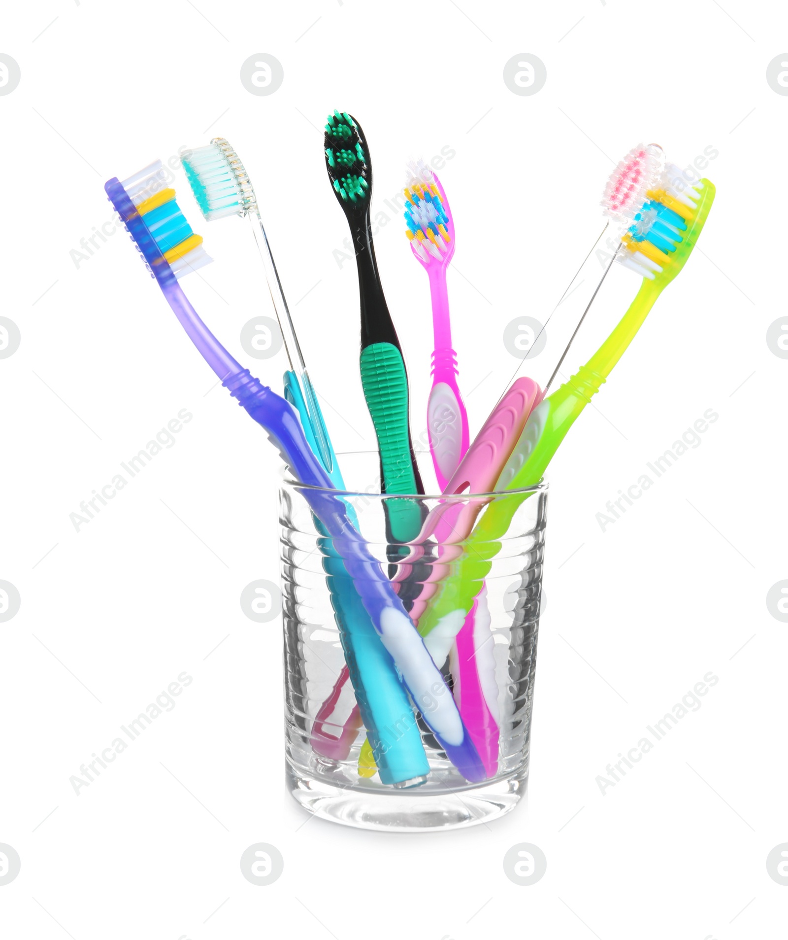 Photo of Cup with different toothbrushes on white background. Dental care