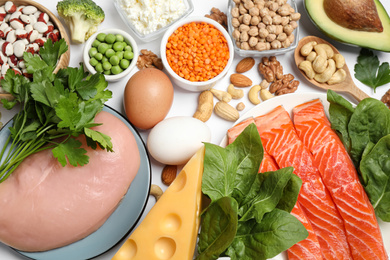 Photo of Different products rich in protein on white background, flat lay