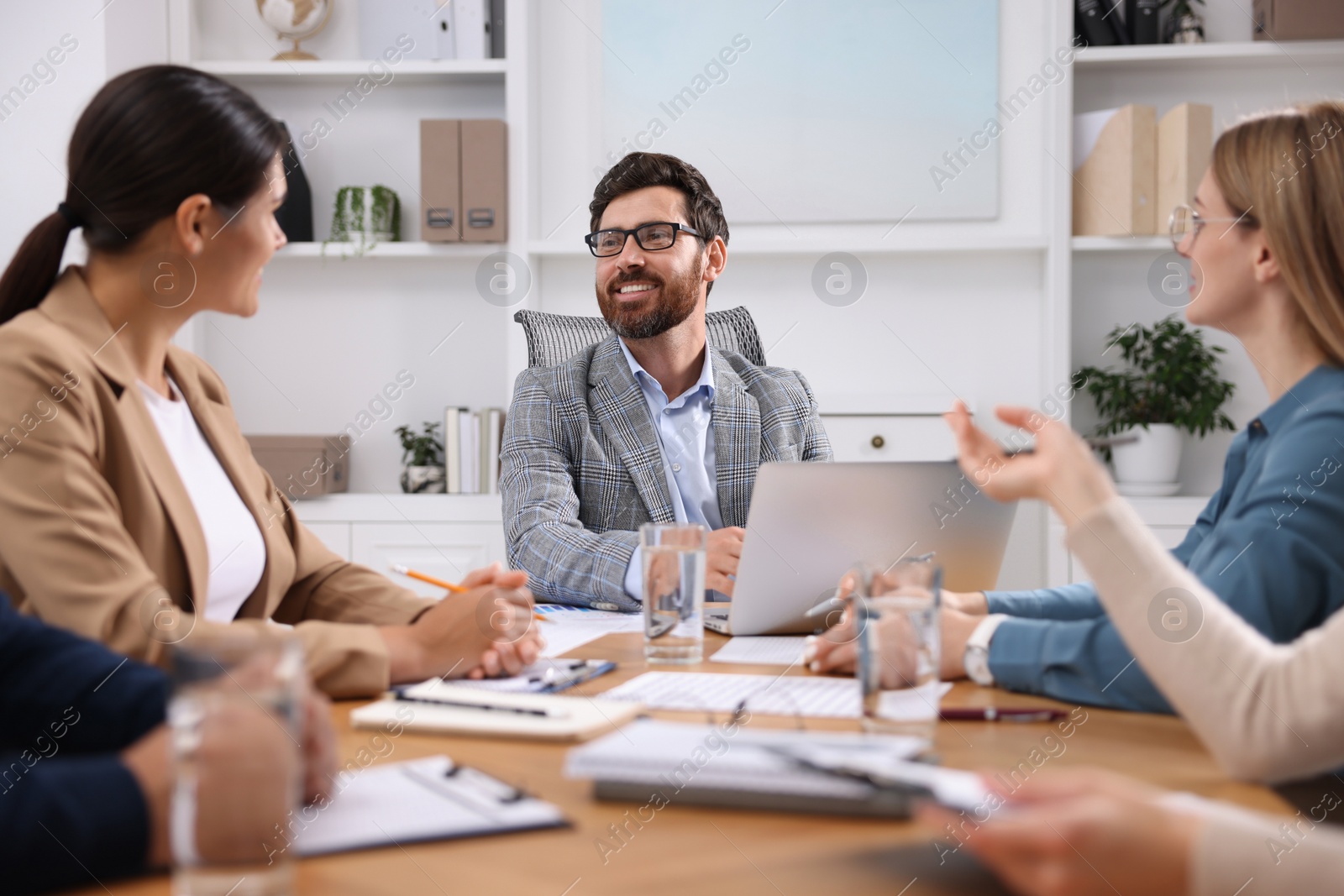 Photo of Team of employees working together in office