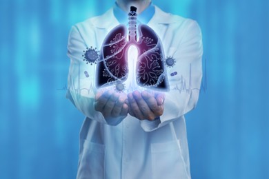 Image of Doctor demonstrating digital image of human lungs affected by virus on blue background, closeup