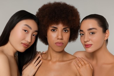 Portrait of beautiful young women on light grey background