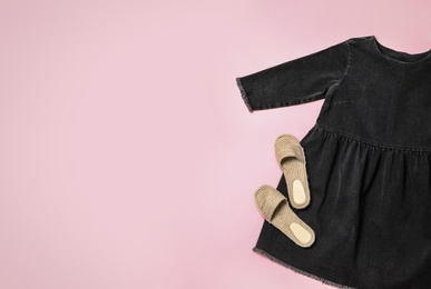 Stylish black dress and shoes on pink background, flat lay. Space for text