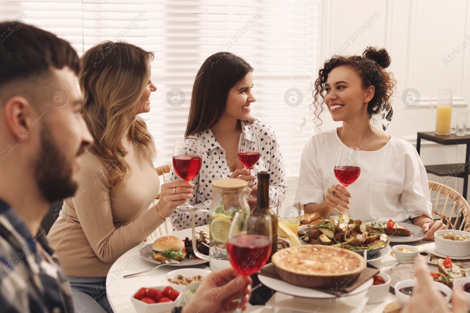 Photo of Group of people having brunch together at table indoors