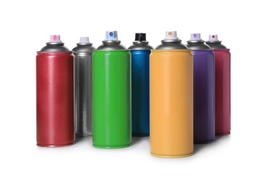 Photo of Cans of different spray paints on white background. Graffiti supplies