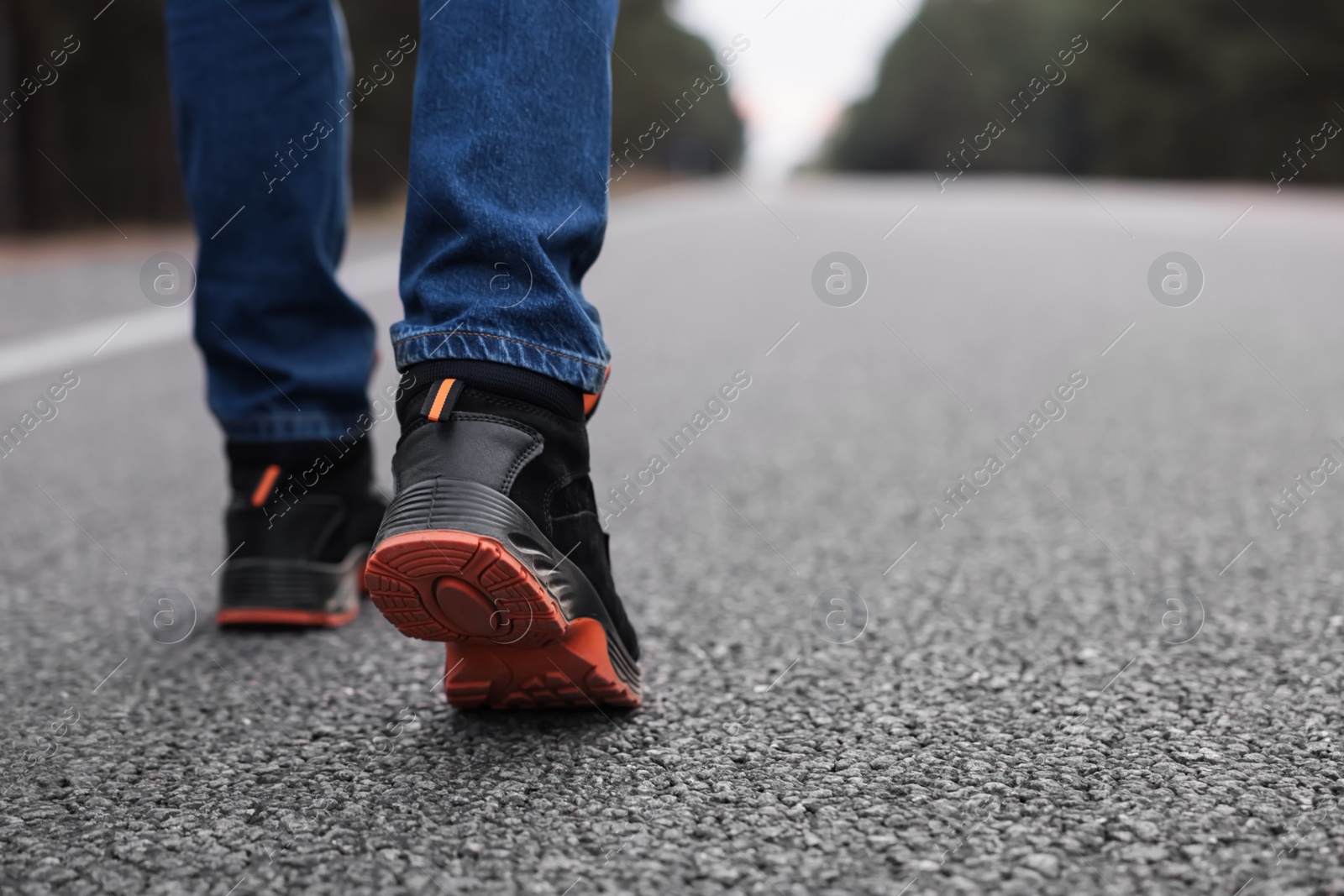 Photo of Man going along road, closeup of legs