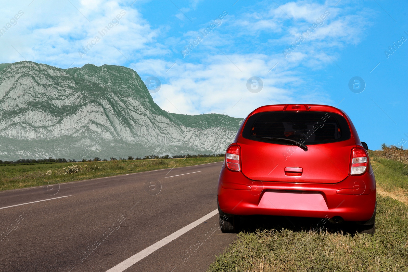 Image of Red car near empty asphalt road in mountains