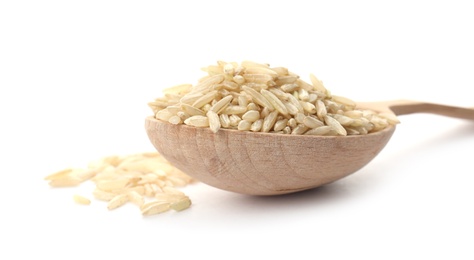 Photo of Wooden spoon with raw unpolished rice on white background, closeup