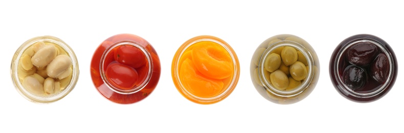 Set of jars with pickled foods on white background, top view. Banner design 
