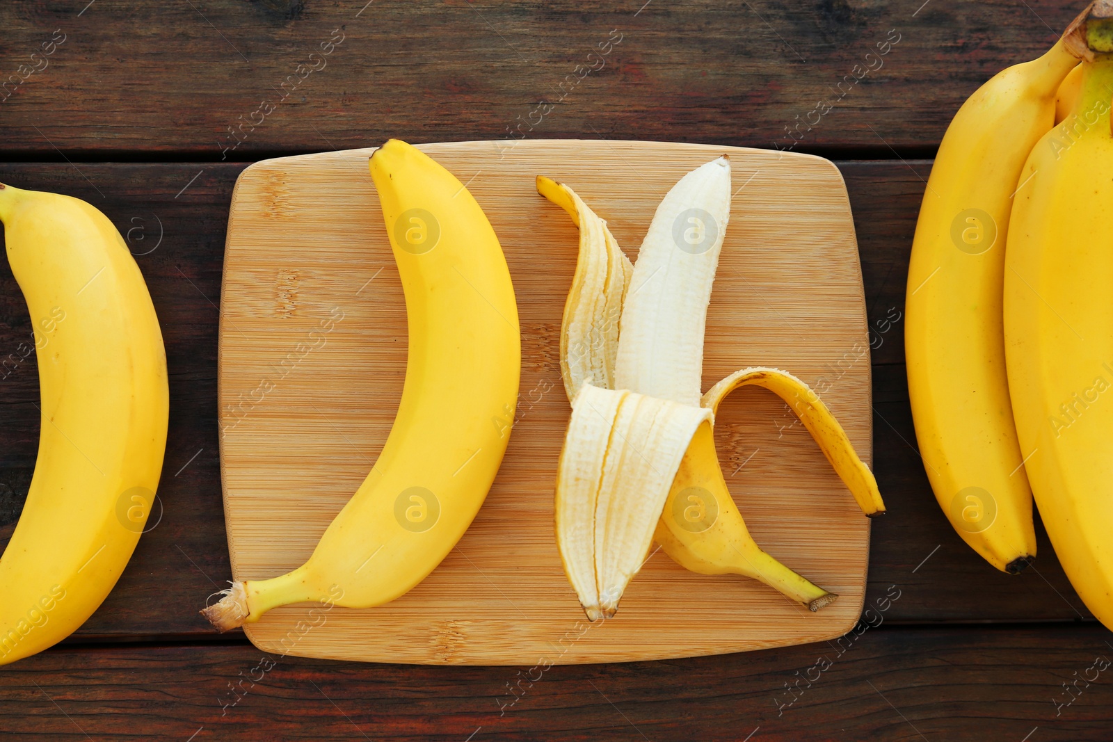 Photo of Delicious bananas on wooden table, flat lay