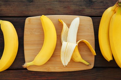 Photo of Delicious bananas on wooden table, flat lay