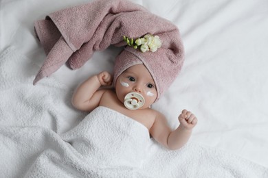 Photo of Cute little baby with cream on face, top view