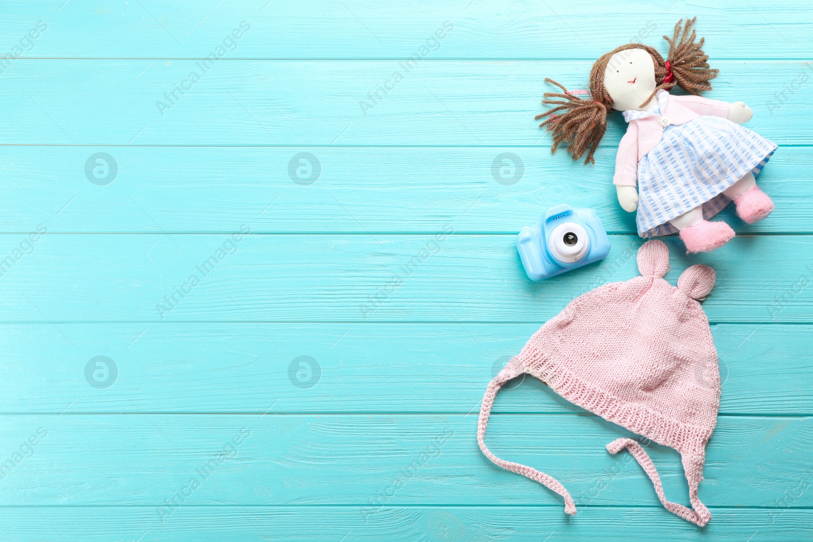 Photo of Flat lay composition with little photographer's toy camera on light blue wooden background. Space for text