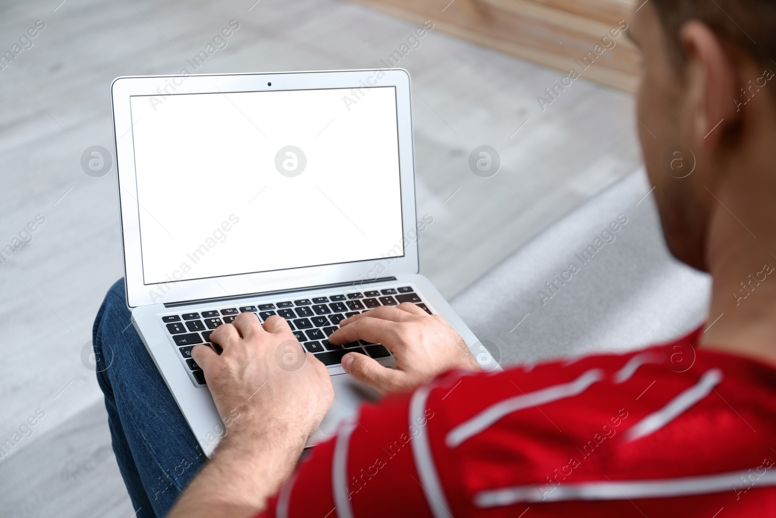 Photo of Man working on modern laptop at home, closeup