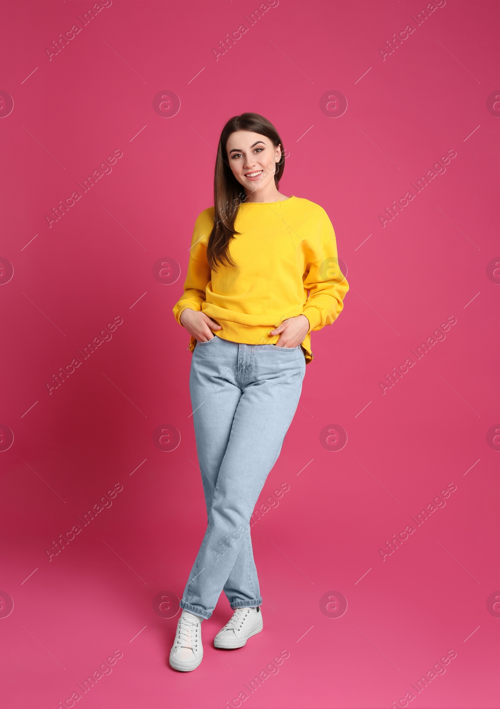 Photo of Full length portrait of young woman on pink background