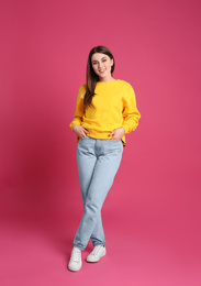 Photo of Full length portrait of young woman on pink background