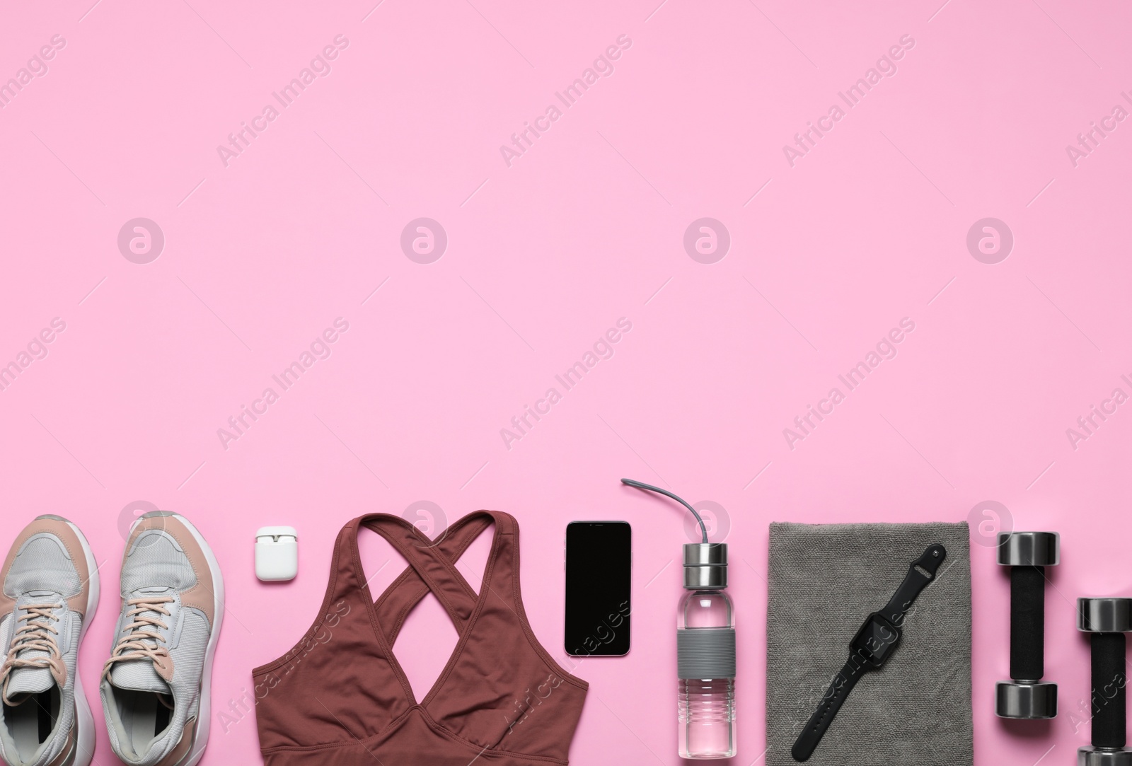 Photo of Flat lay composition with sports equipment on pink background, space for text