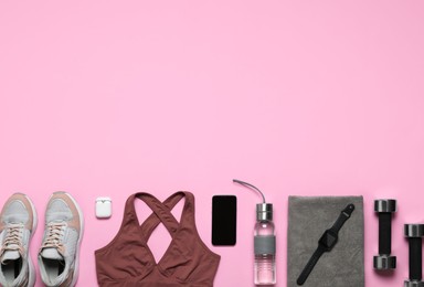 Flat lay composition with sports equipment on pink background, space for text