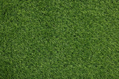 Photo of Green artificial grass as background, top view