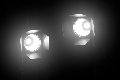 Bright spotlights in darkness. Professional stage equipment