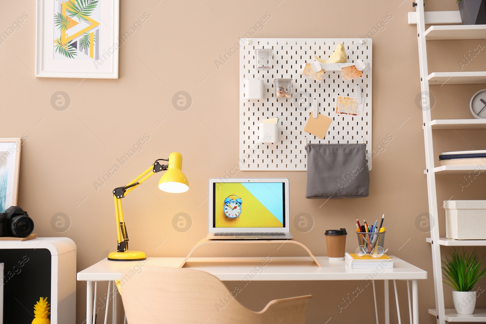 Photo of Modern laptop on desk in room. Home workplace