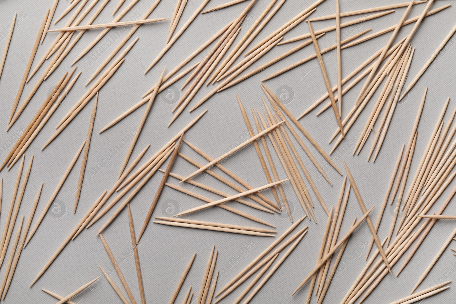 Photo of Wooden toothpicks on grey background, flat lay