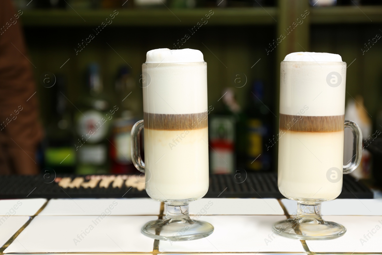 Photo of Tasty coffee drinks on table in cafe