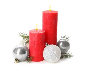 Beautiful burning candles with Christmas decor on white background