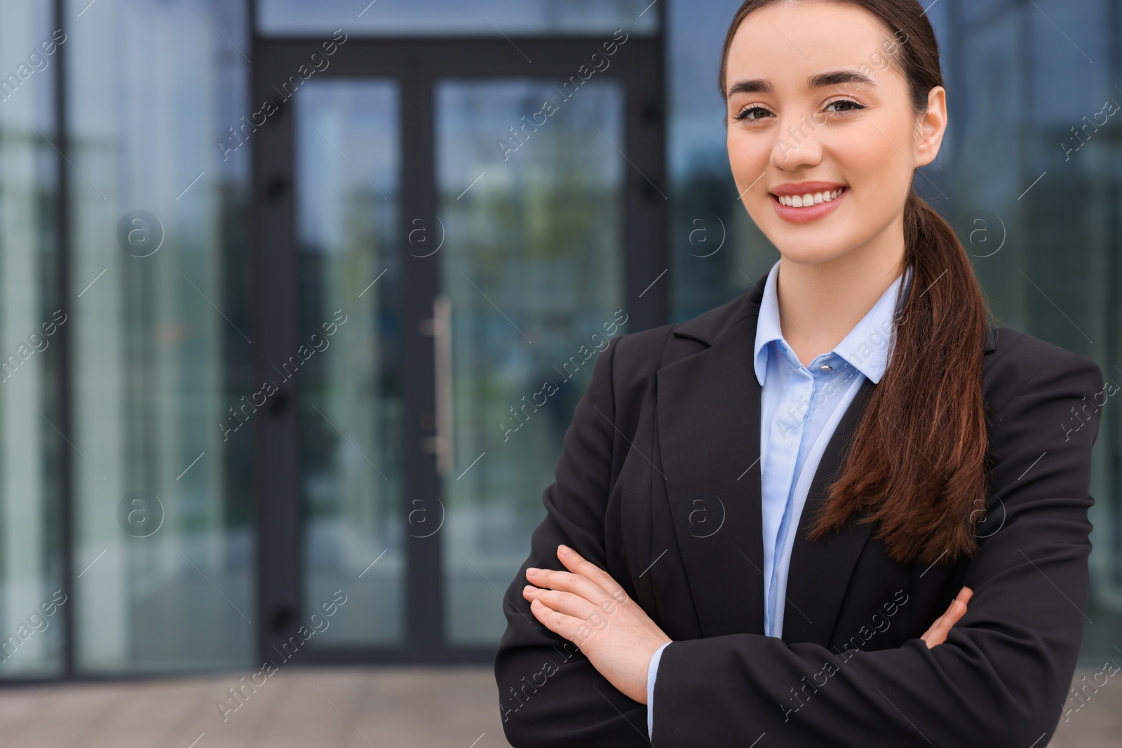 Photo of Happy real estate agent outdoors. Space for text