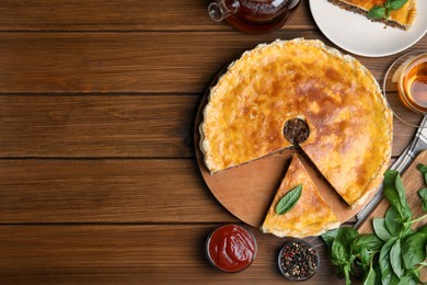 Delicious pie with minced meat served on wooden table, flat lay. Space for text
