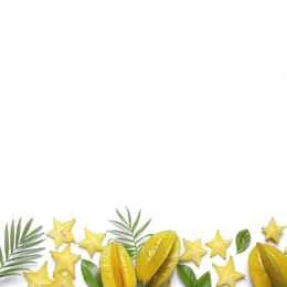 Delicious carambola fruits and leaves on white background, flat lay