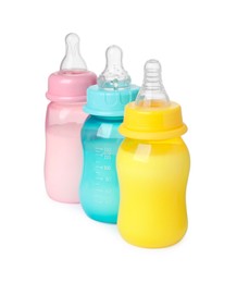 Photo of Feeding bottles with milk on white background