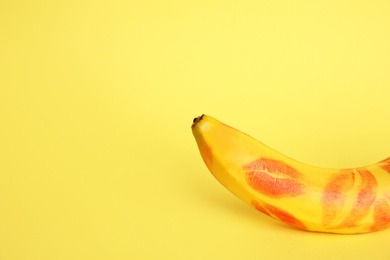 Photo of Fresh banana with red lipstick marks on yellow background, space for text. Oral sex concept