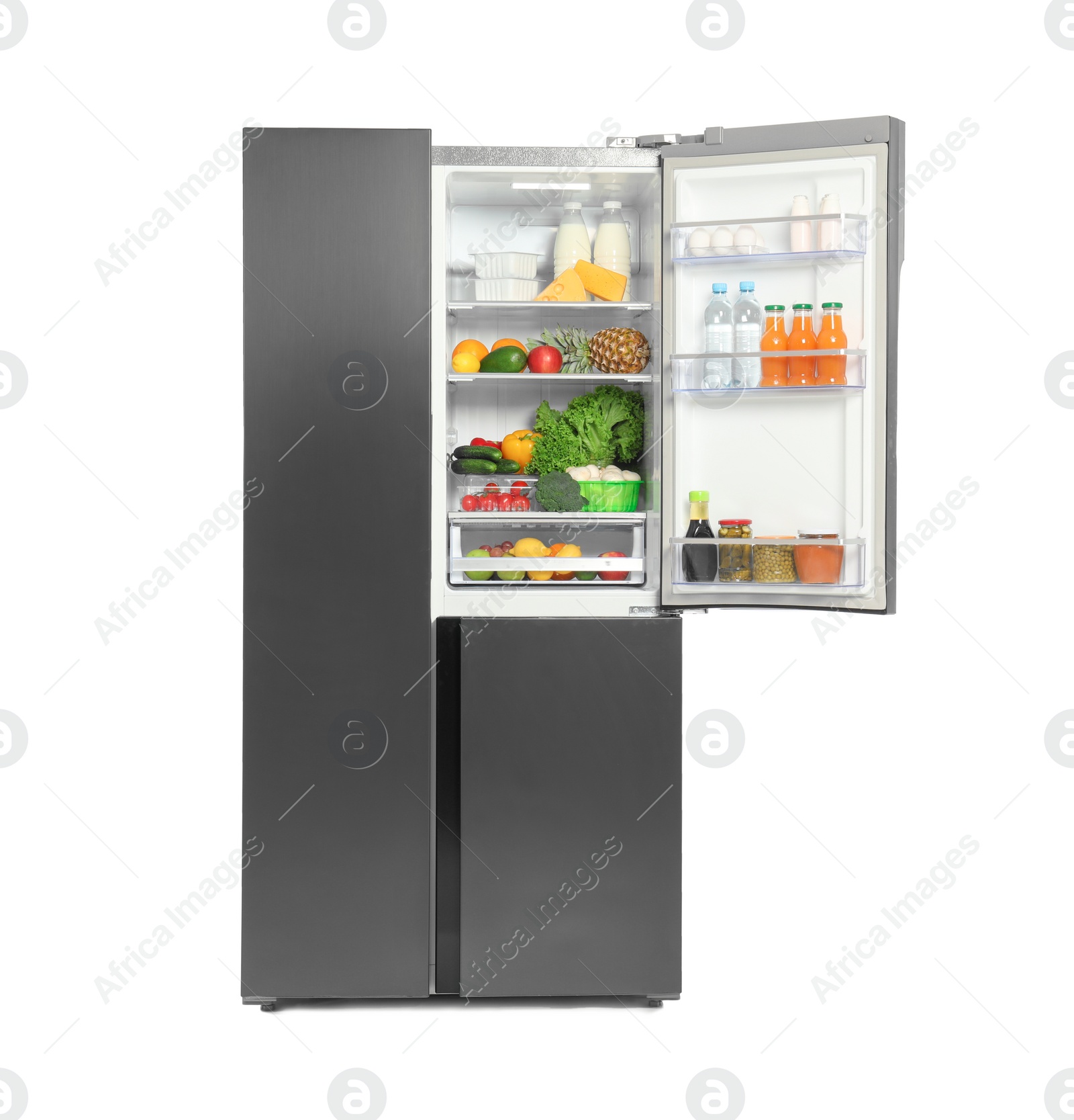 Photo of Open refrigerator full of different products isolated on white
