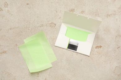 Photo of Facial oil blotting tissues on light grey background, flat lay. Mattifying wipes