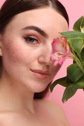 Beautiful woman with fake freckles and flower, closeup