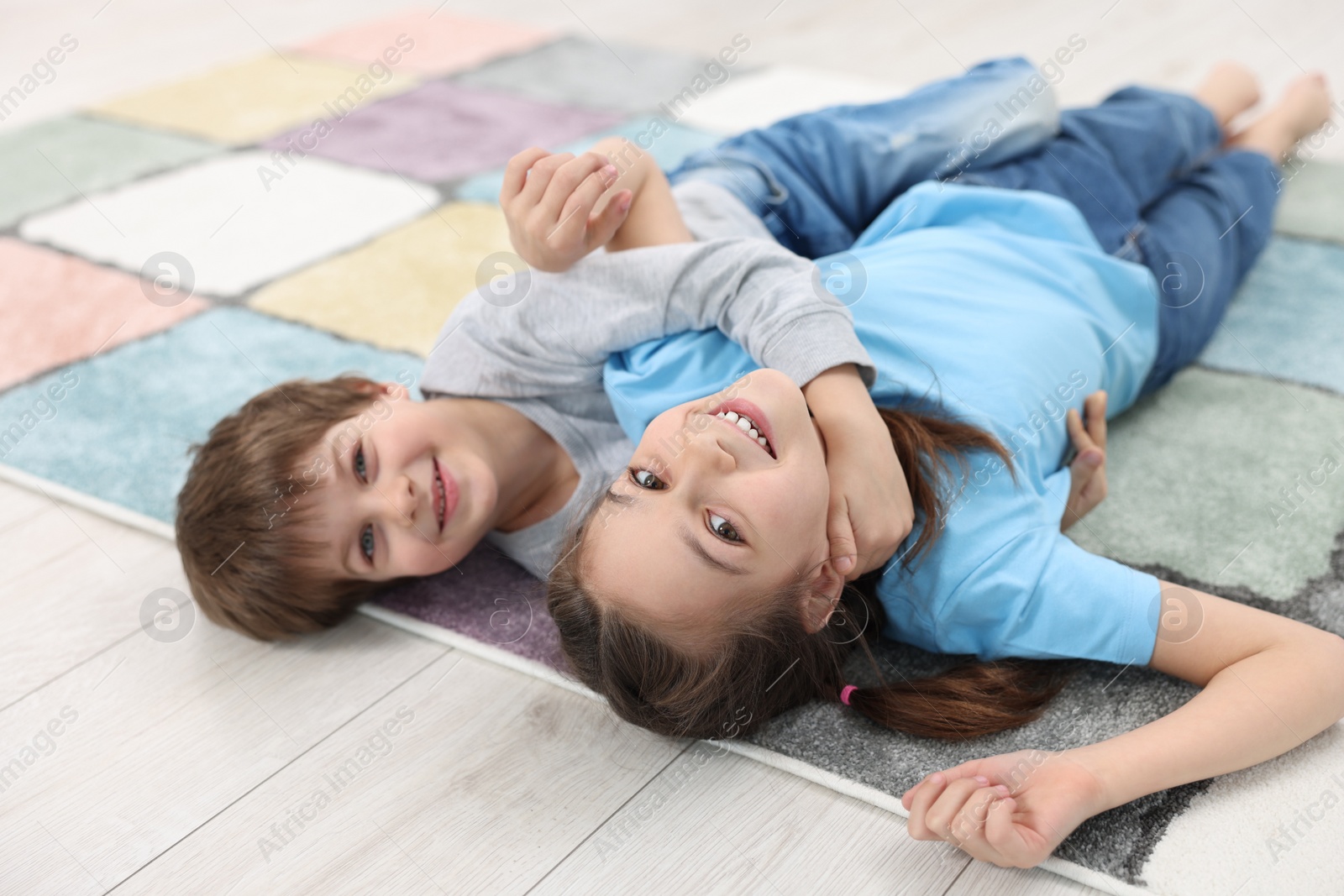 Photo of Happy brother and sister spending time together indoors